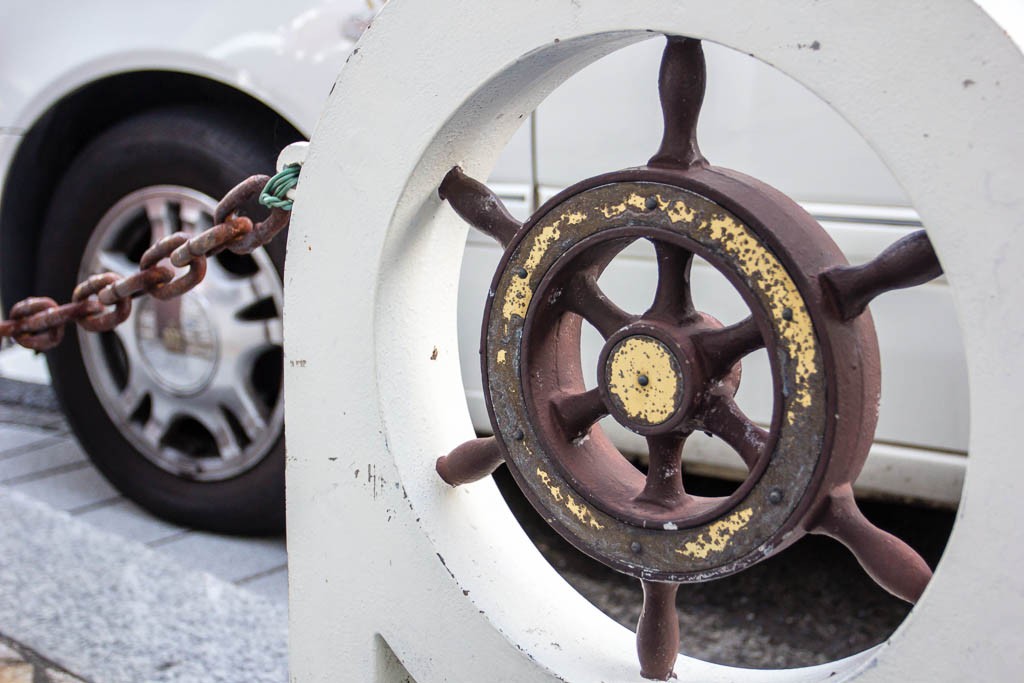 Wheel of a taxi and the wheel of a ship. Interesting contrast.