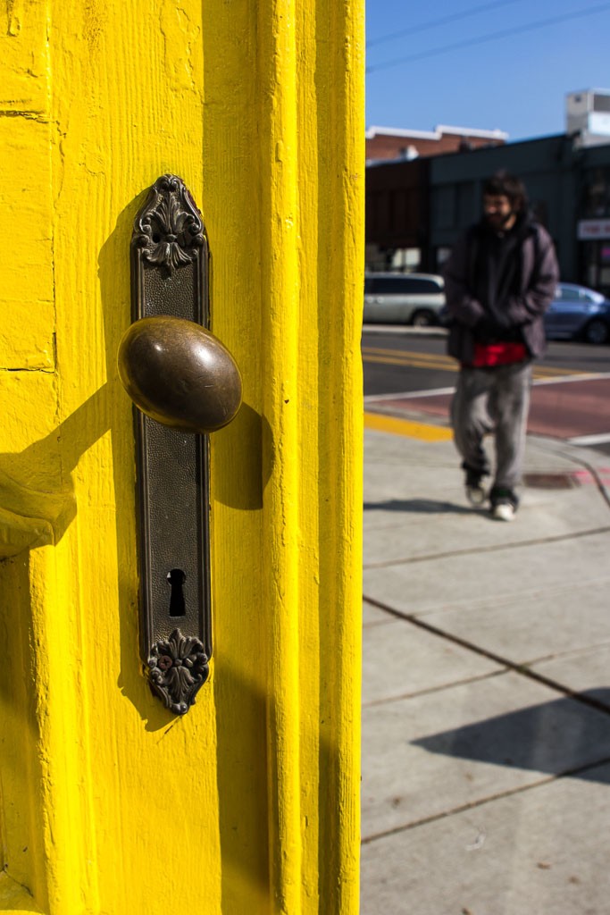 Yellow door with vintage doorknob.