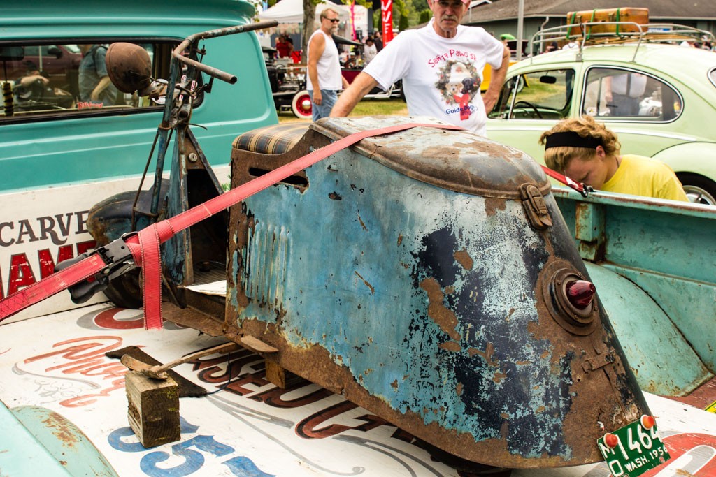 Old scooter in the back of an old truck.