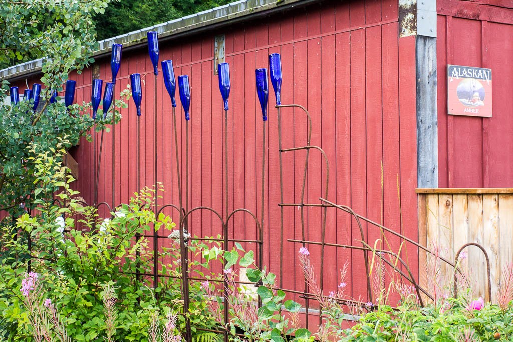 It's like a "bottle tree" only on a fence! Brilliant idea. I may put one in my backyard. 