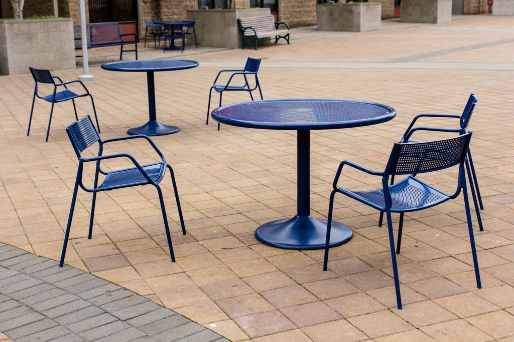 Blue chairs and tables in the courtyard.  They're way heavier than they look.