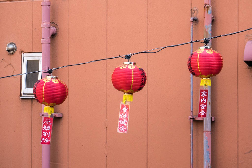 Lanterns against a building wall