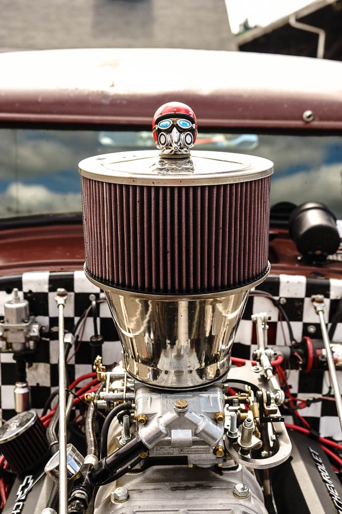 Little drag racing helmet on the air cleaner bolt.