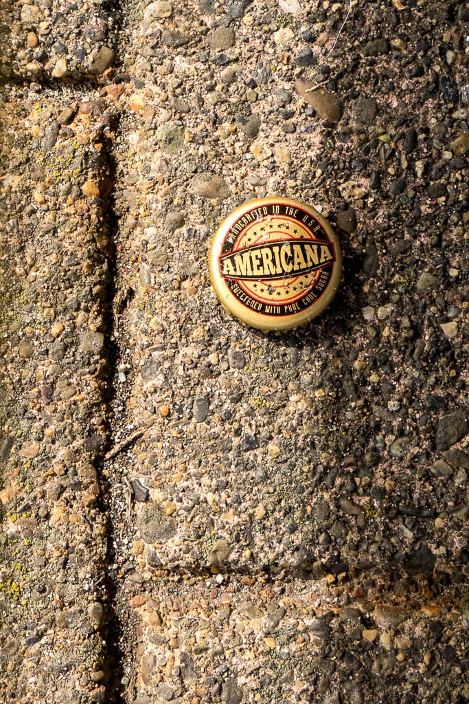 I shot this bottle cap through the slats in a park bench for some reason. I ended up cropping a ton but I like the lines and final layout.