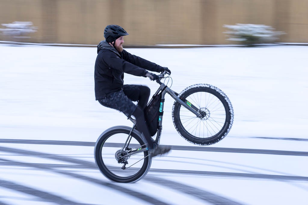 Jason playing on his bike in the snow